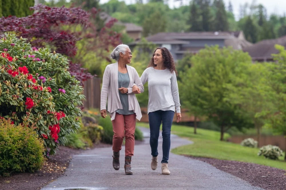 Two women, one older and one younger, walk near a Boca Raton vein treatment center.