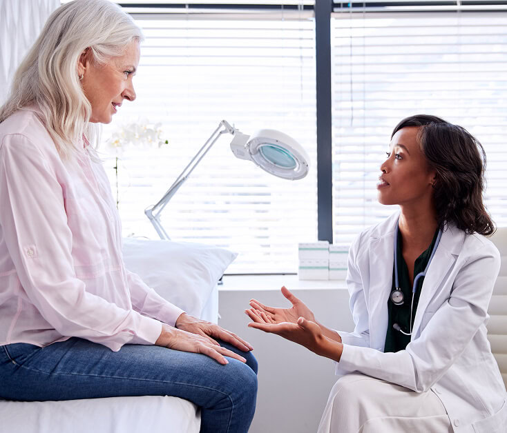 A vein specialist discusses breast vein treatment options with a patient in Boca Raton.