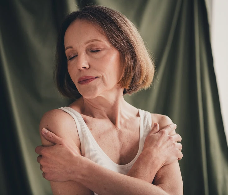 A woman embraces herself after vein treatment at a Boca Raton vein center.