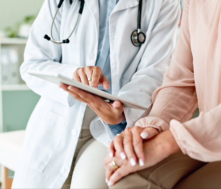 A Boca Raton vein doctor discusses varicose vein treatment options with a patient.