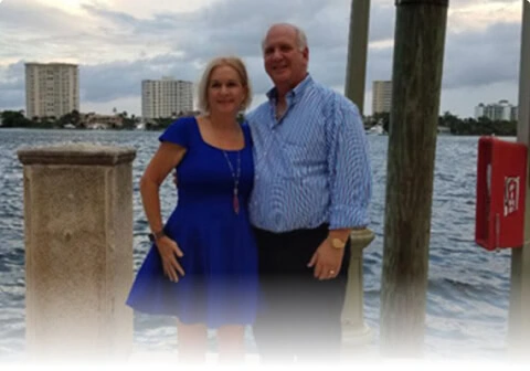 A couple by Boca Raton waterfront near vein treatment center for vein disease.