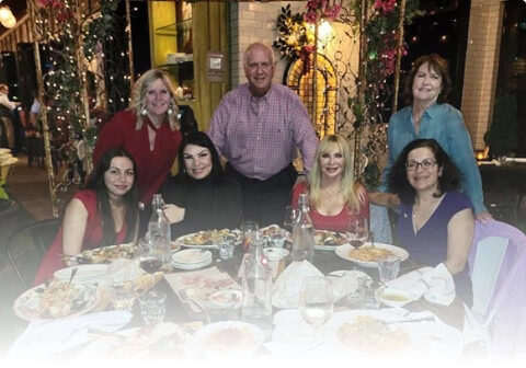 Seven adults at a Boca Raton vein treatment center celebrate vein health together.