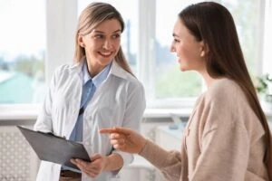 A vein specialist discussing hand vein treatment options with a patient