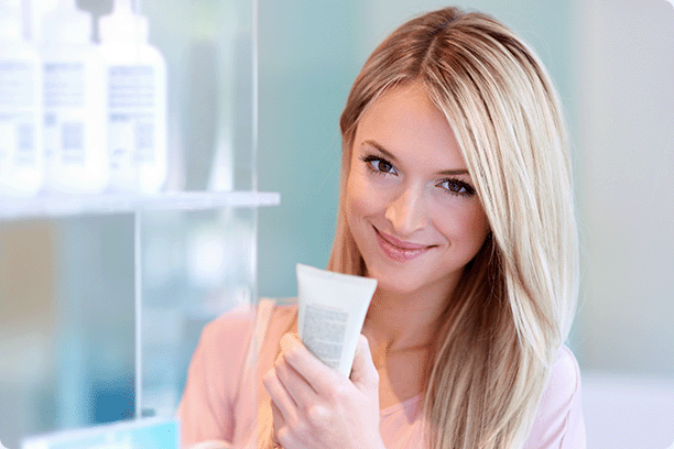 attractive middle-aged woman holding a skin product